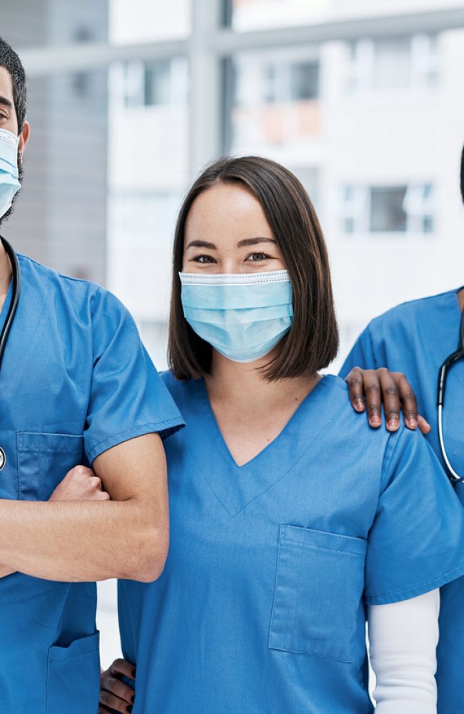 Portrait of a group of medical practitioners wearing face masks in a hospital